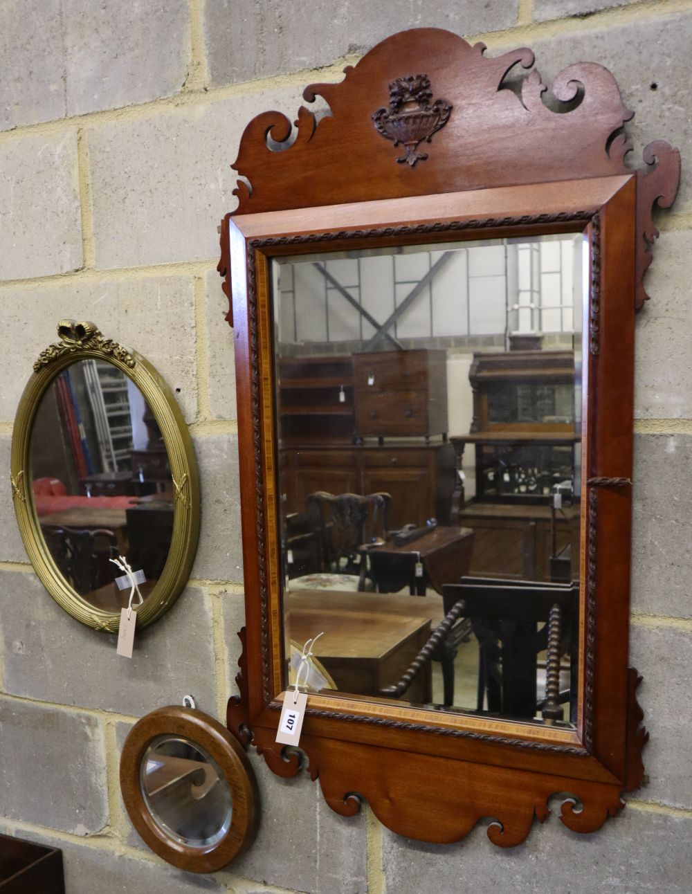 A George III style fret cut wall mirror and two others, tallest 102cm